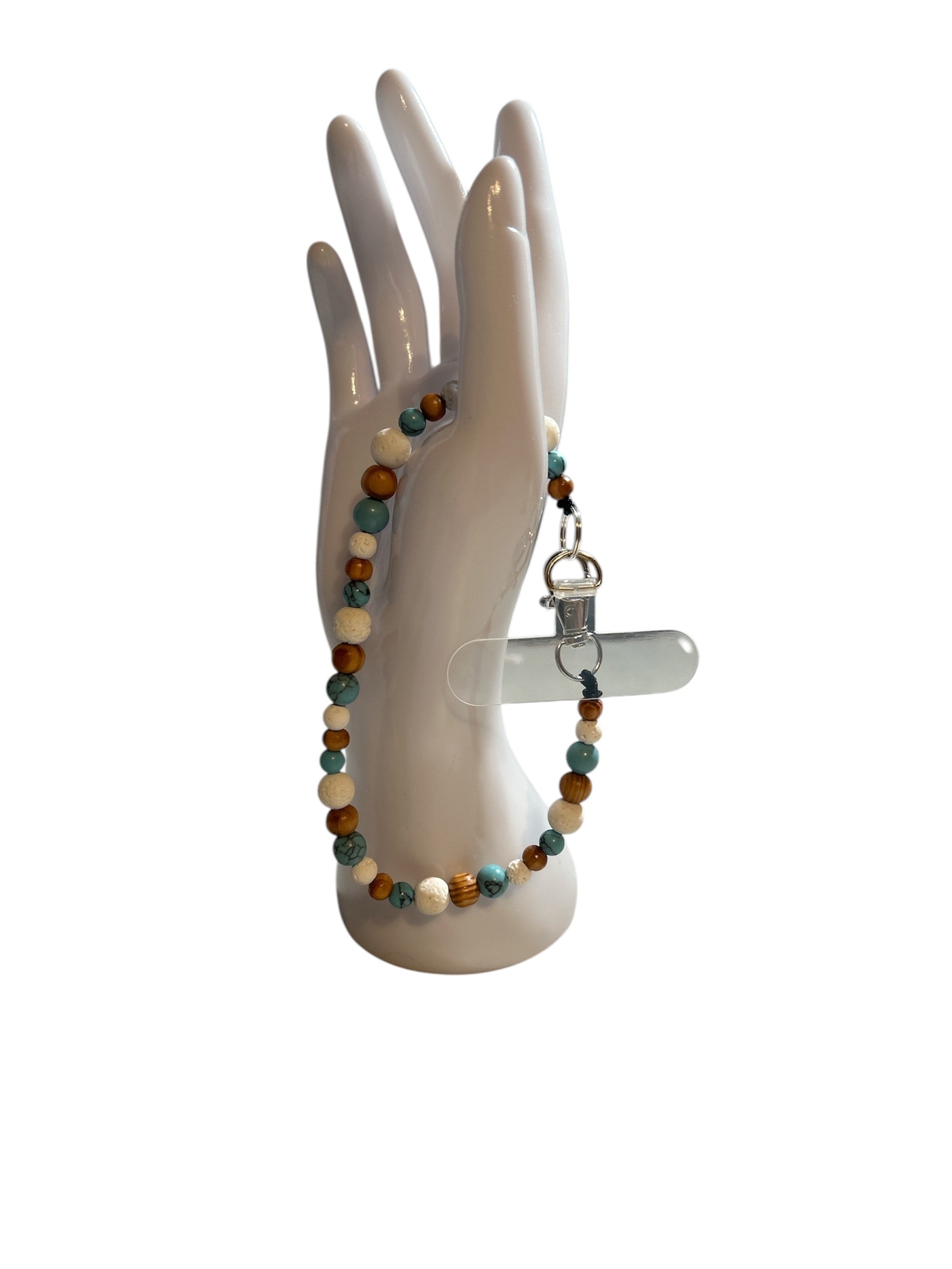 Attache cellulaire turquoise et pierre de lave blanche